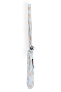 Light blue crossbody bag with orange sunburst pattern and adjustable strap