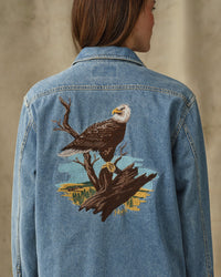 Women's denim shirt back view featuring large embroidered bald eagle on branch design