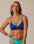 Women's navy blue bikini top with twist front detail and thin straps, front view