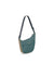 Crescent-shaped crossbody pouch with teal upper, tan lower panel, front zip pocket, and adjustable gray strap