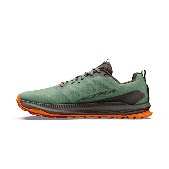 Trail running shoe in green with orange lugged outsole, lateral side view