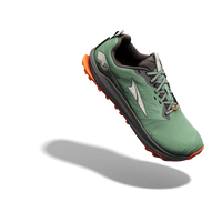 Trail running shoe in green with orange sole accents, three-quarter angle view showing lacing and tread