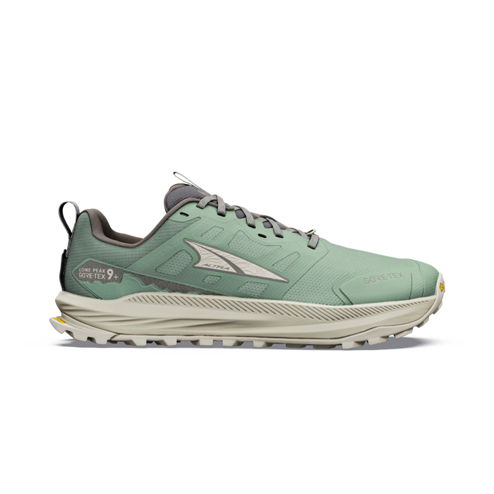 Trail running shoe with mint green upper, beige midsole, aggressive lug outsole, lateral view