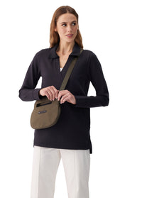 Olive green crossbody bag with logo strap, worn across body by model, front view