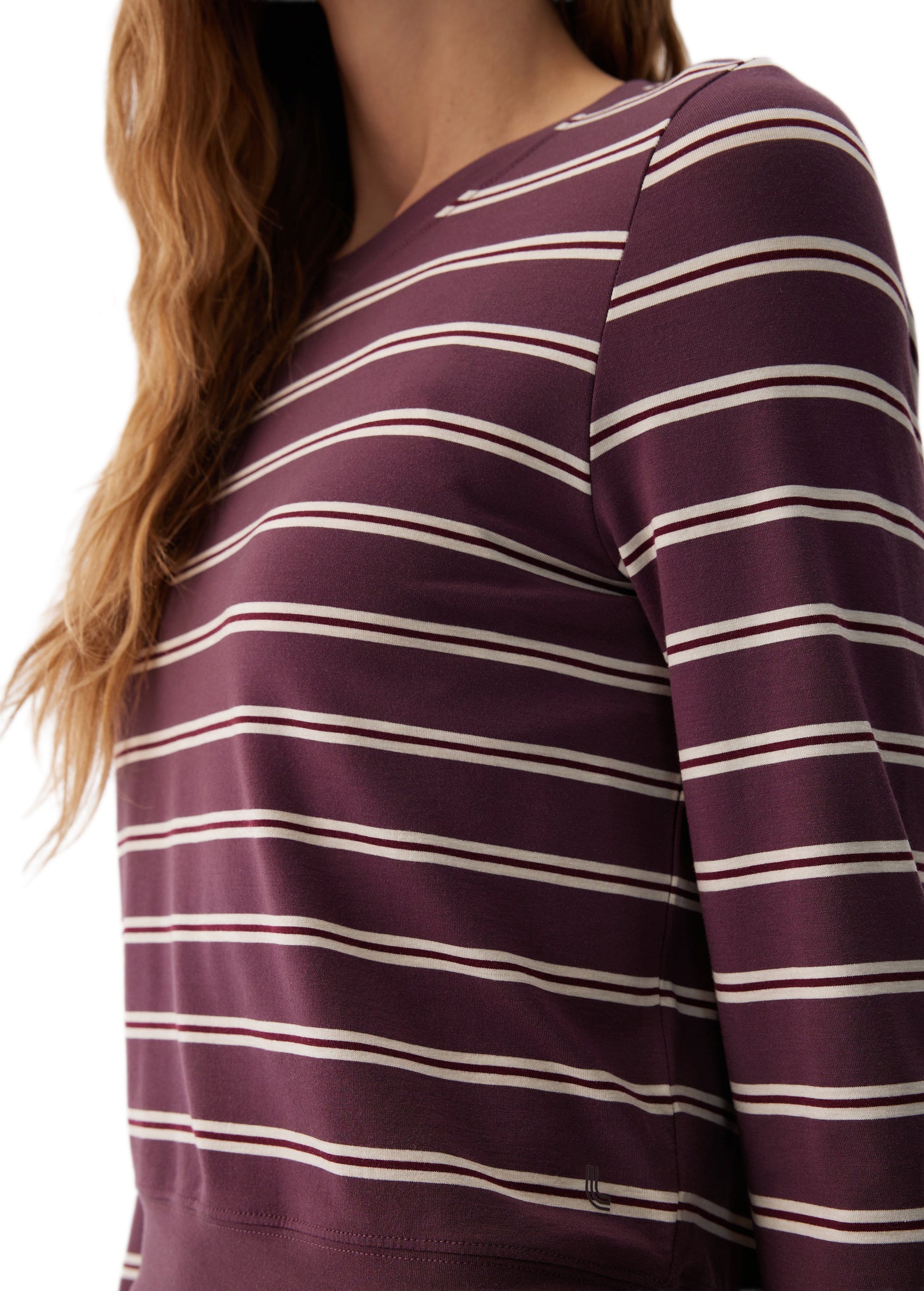 Women's long sleeve top in dark purple with cream horizontal stripes, close-up detail view