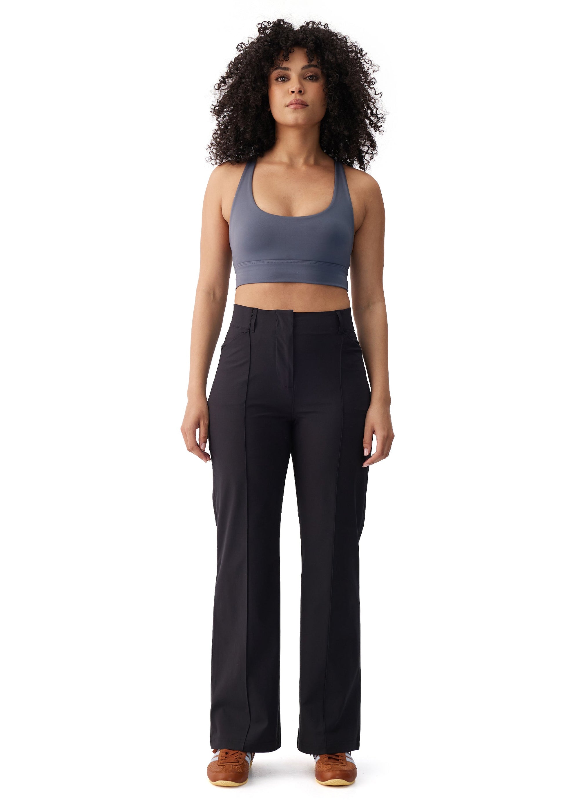 Black high-waist wide-leg travel trousers with front seam detail, full-length front view on model