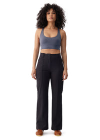 Black high-waist wide-leg travel trousers with front seam detail, full-length front view on model