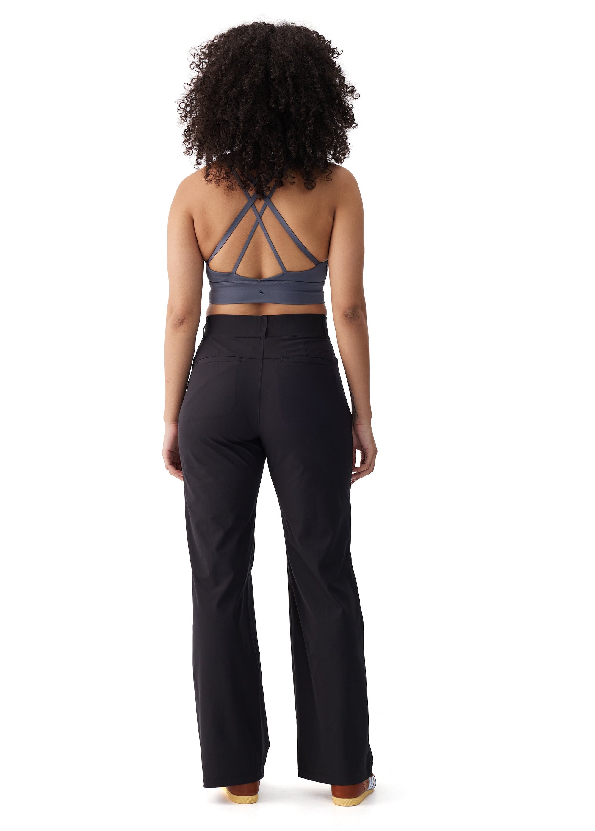 Black wide-leg travel trousers shown from the back on a female model