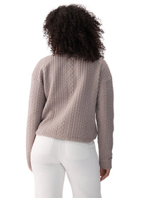 Women's cable-knit long sleeve pullover top, back view, shown in warm taupe