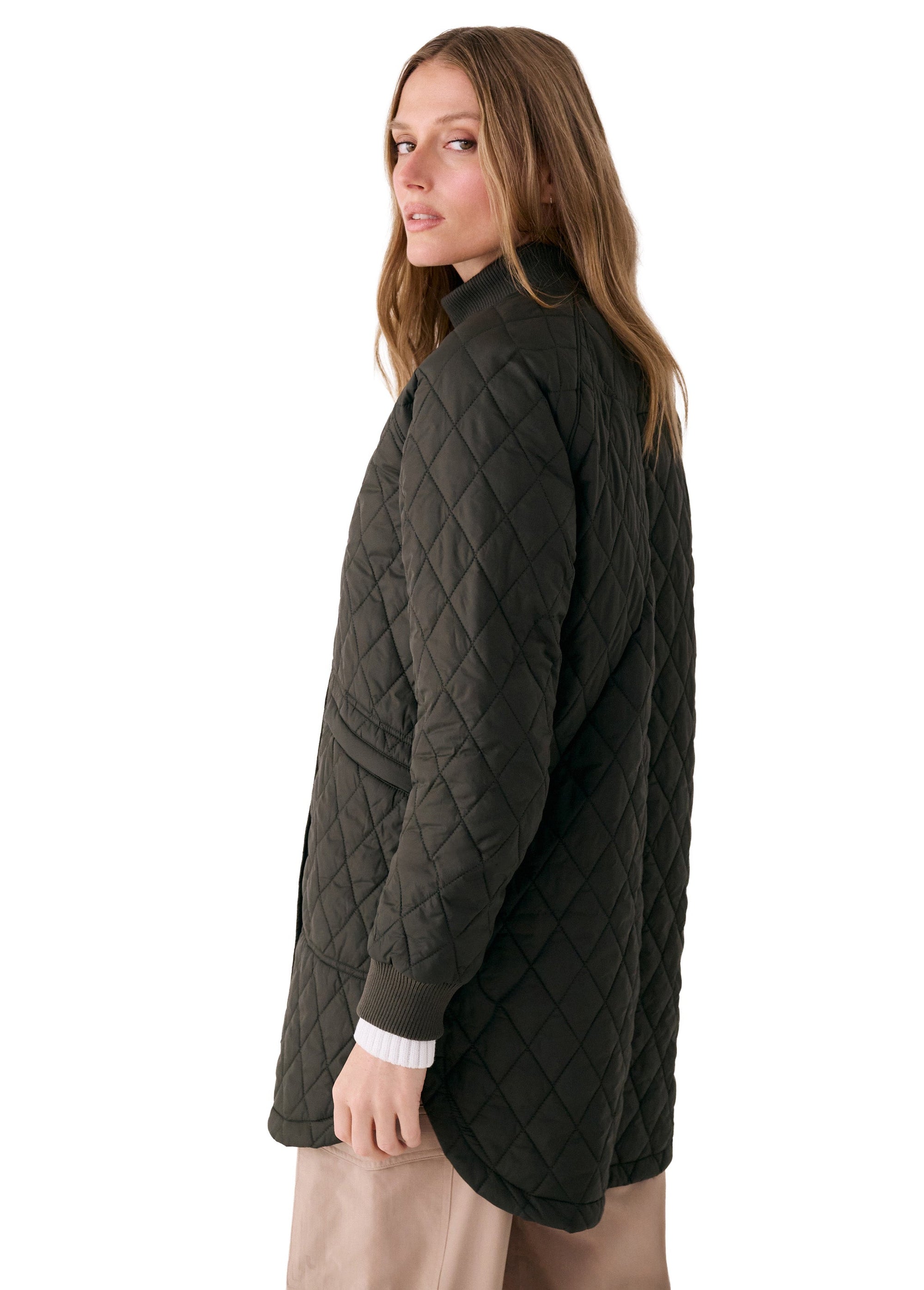 Women's quilted 3/4 length bomber jacket in dark olive, side view on model