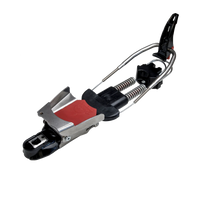 Telemark ski binding with chrome spring bail, black toe piece, and red accent plate, side angle view