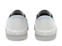 Light colored canvas slip-on sneakers shown from heel view on white background