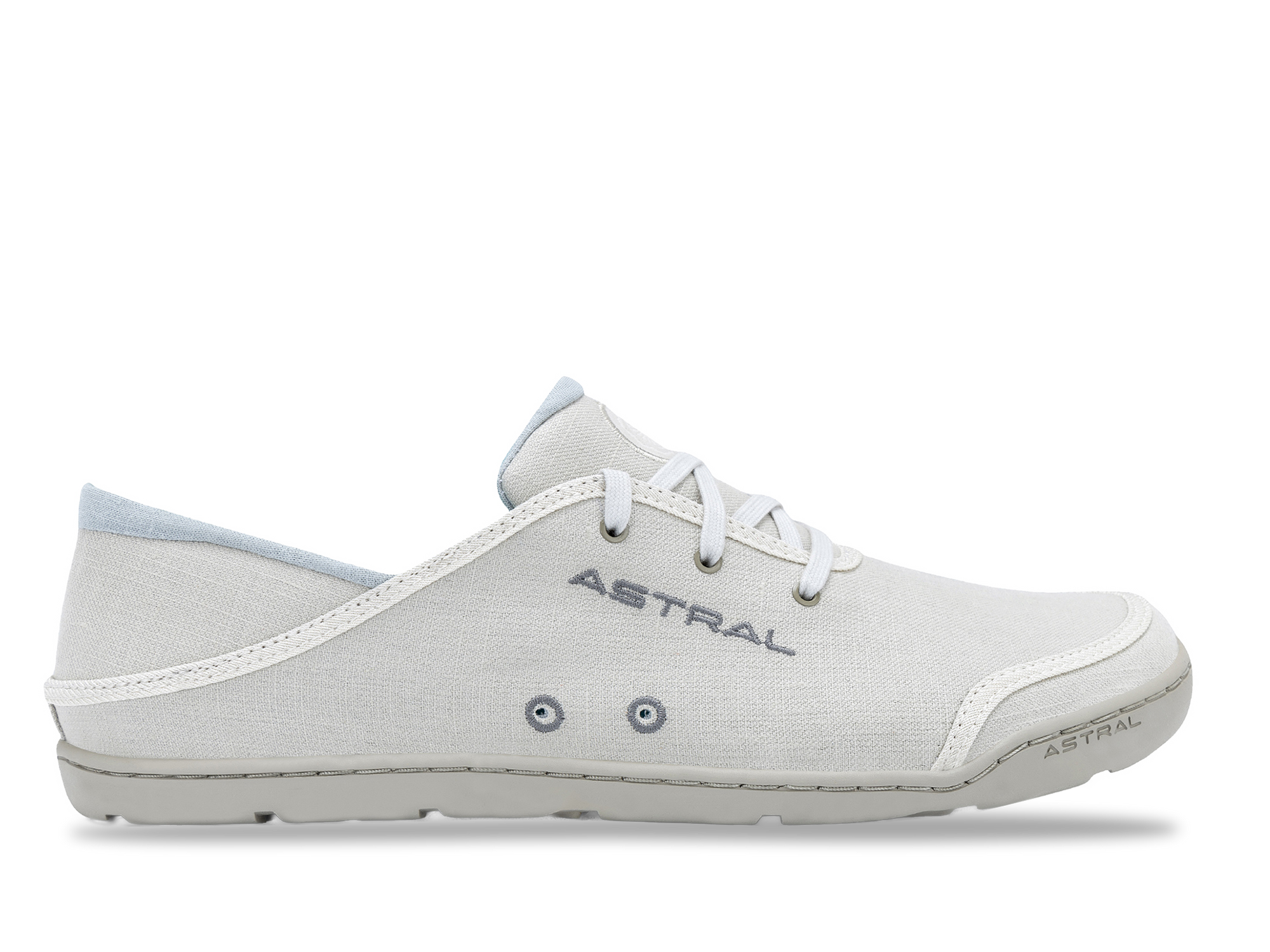 Light colored canvas sneaker with white laces and textured sole, side profile view