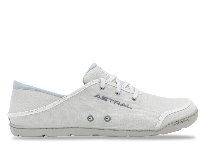 Light colored canvas sneaker with white laces and textured sole, side profile view