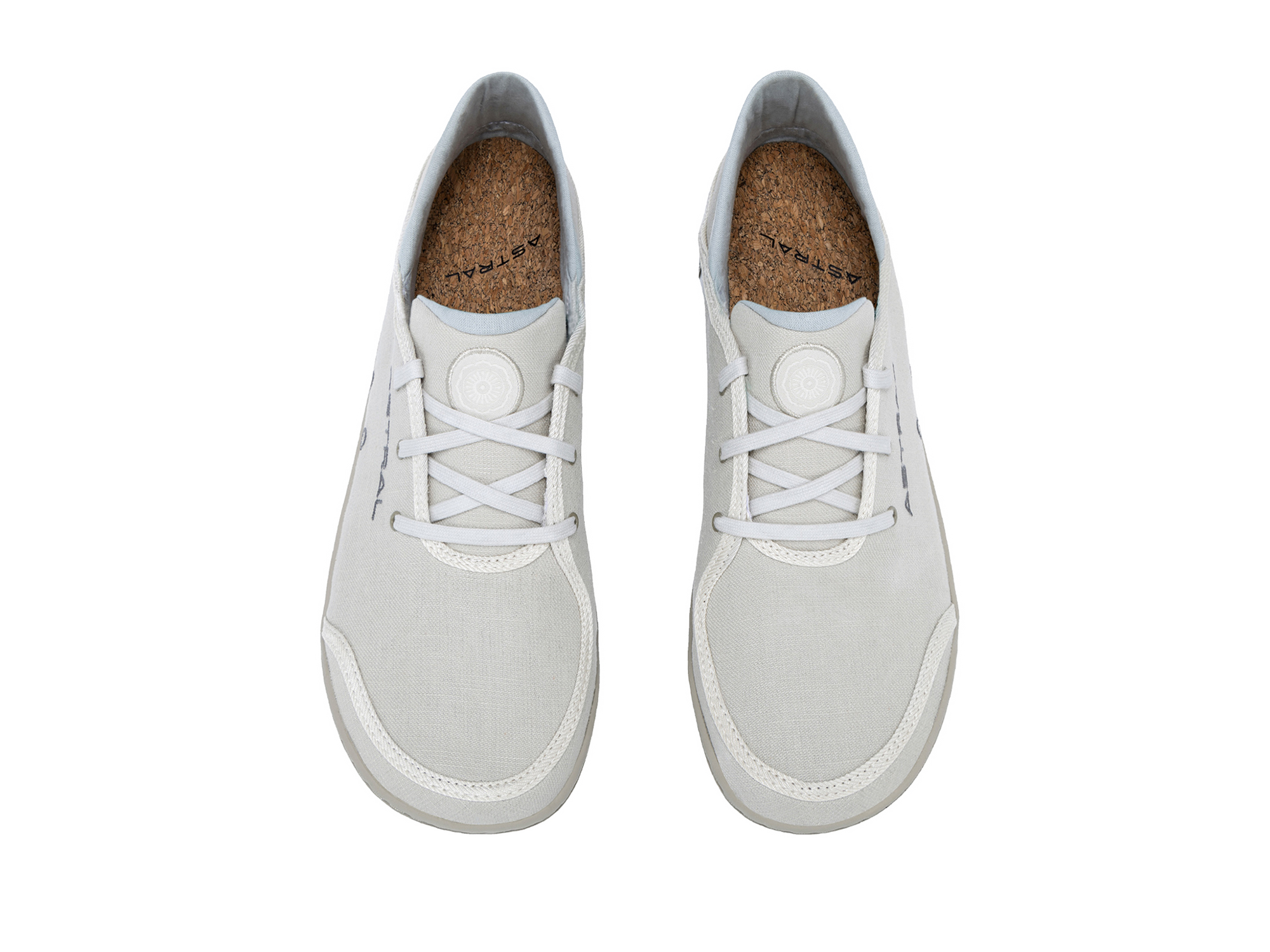 Light gray canvas sneakers with white laces and cork insoles, top-down view