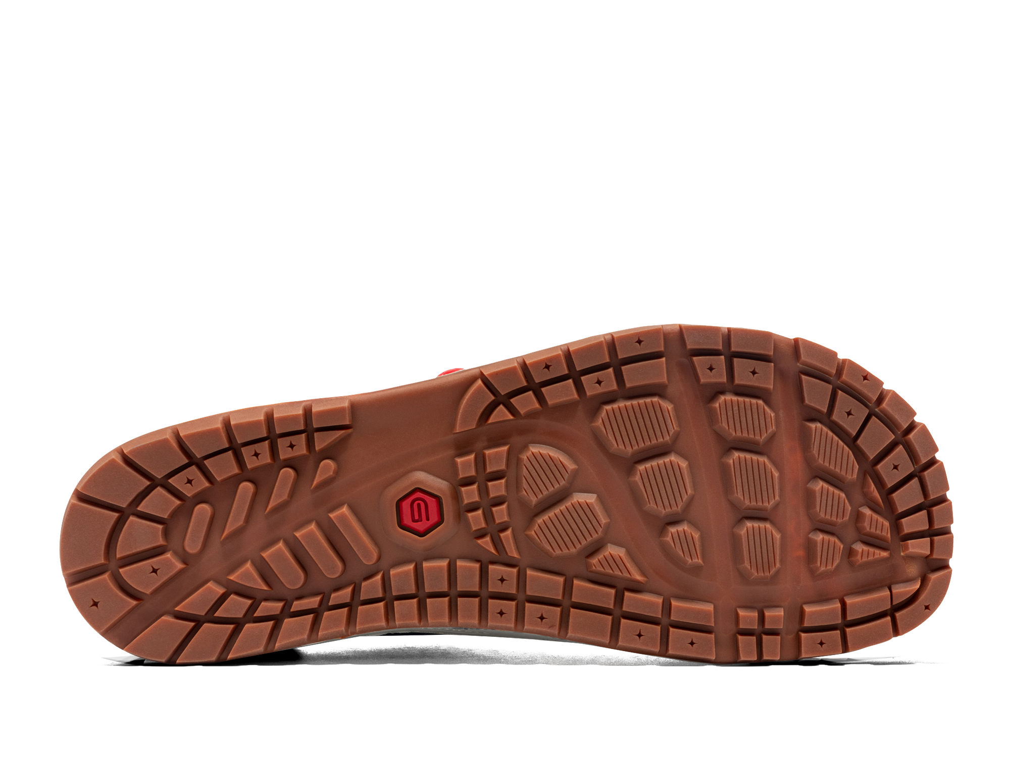 Brown rubber sole of outdoor shoe showing circular tread pattern and grip lugs