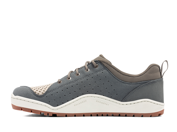 Gray outdoor sneaker with perforated upper, cream mesh toe, and brown rubber sole, side view