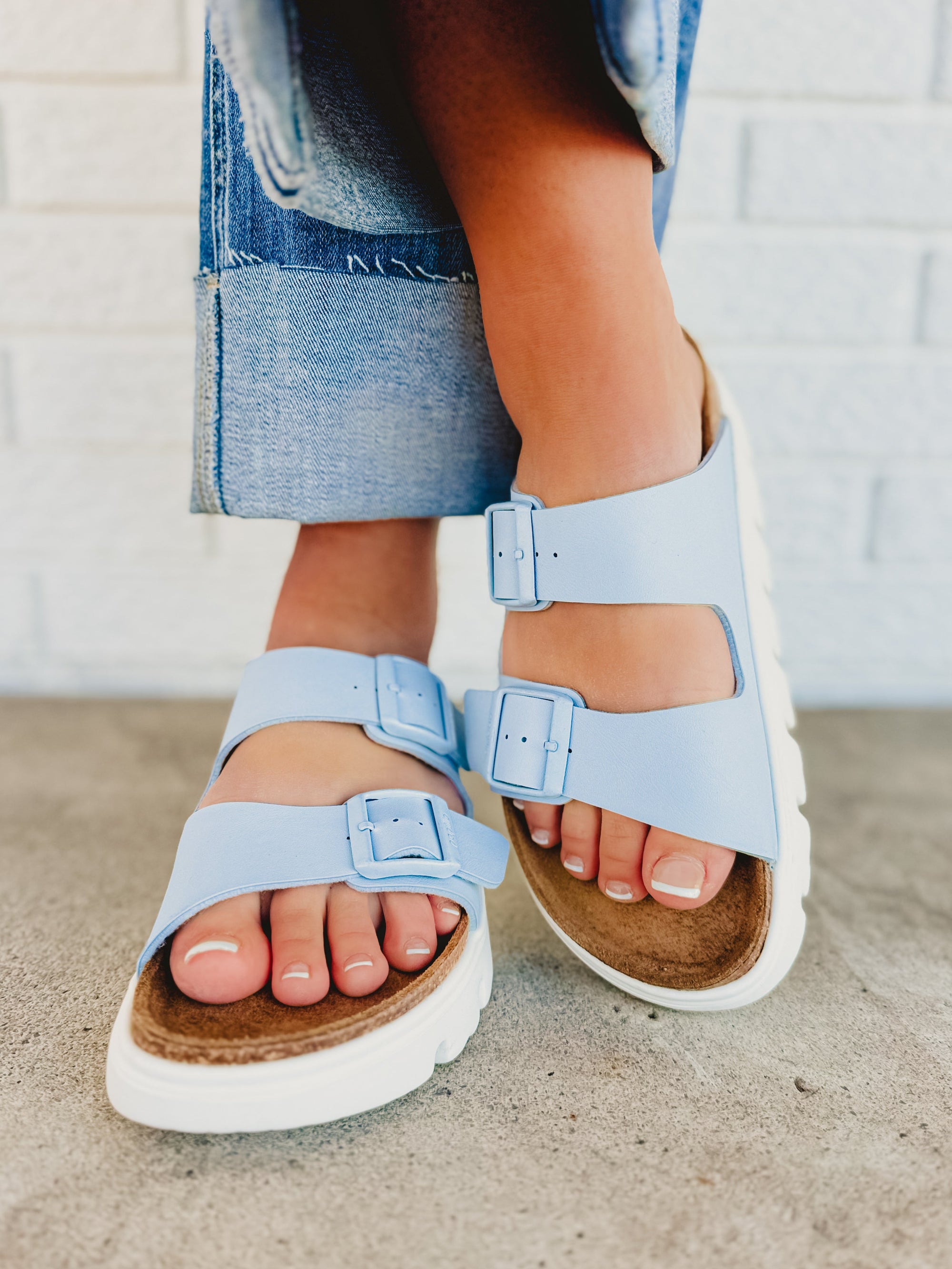 Light blue chunky platform sandals with adjustable buckle straps and cork footbed