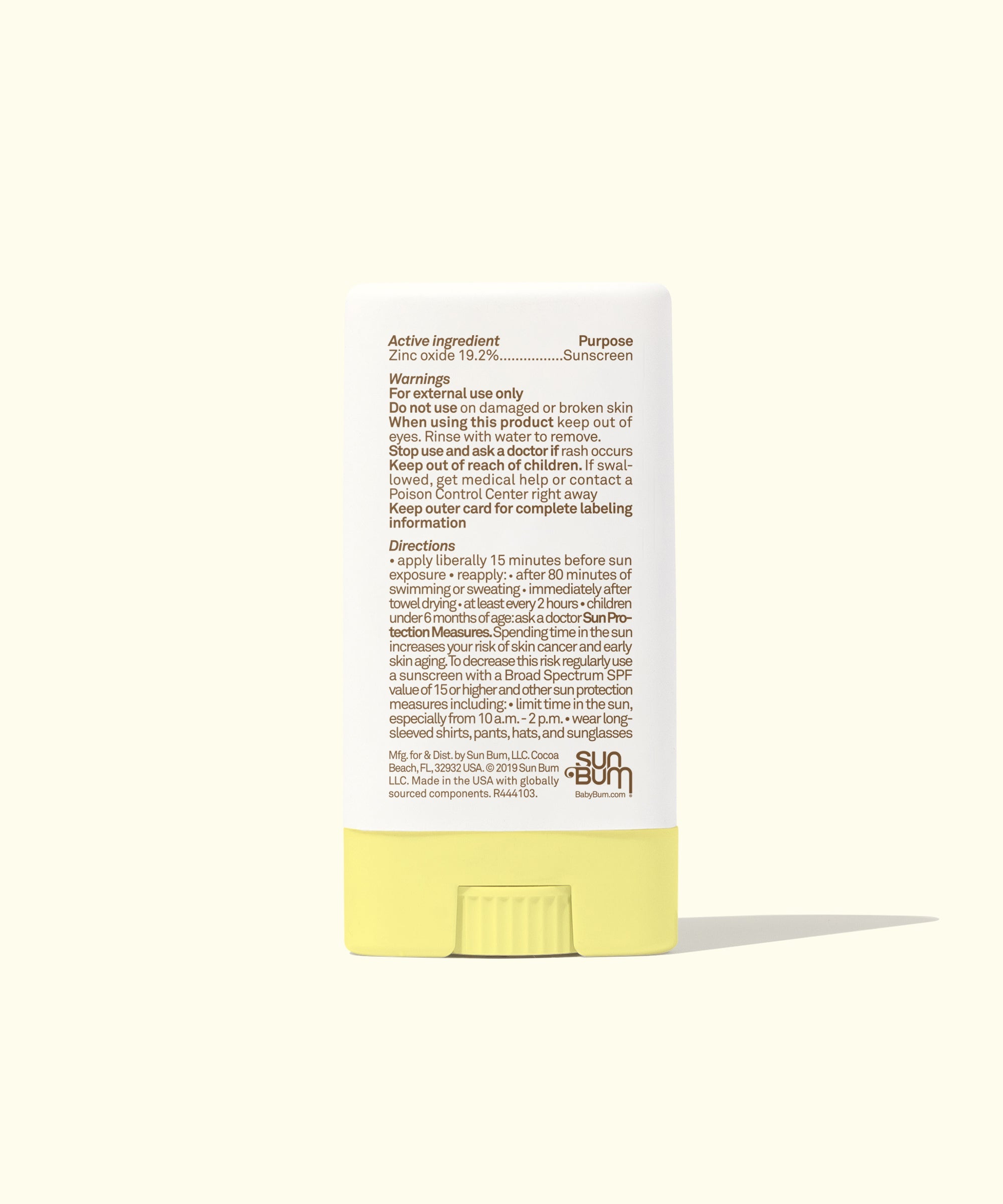 Yellow mineral sunscreen face stick showing product label and ingredients on clean background
