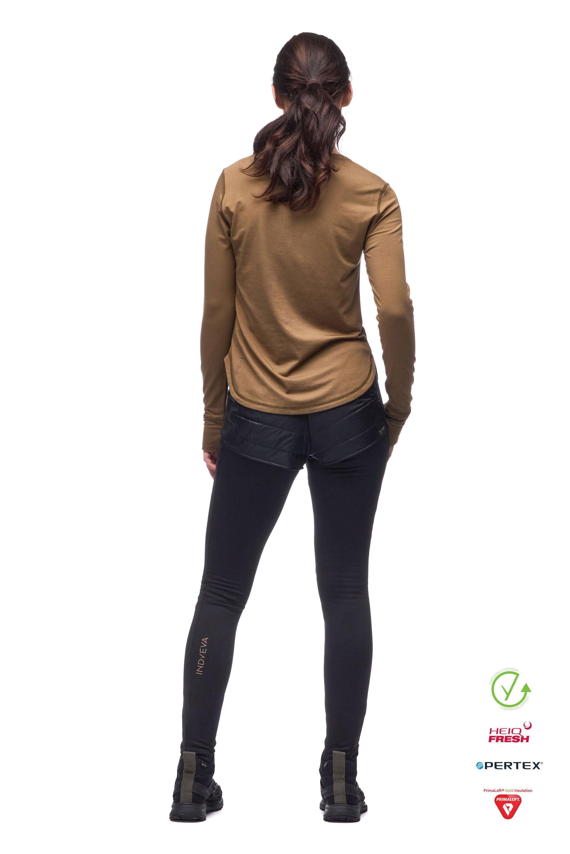 Women's black athletic tights with insulated shorts overlay, back view on model