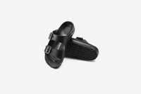 Black two-strap sandals with adjustable buckles and textured footbed, shown from above