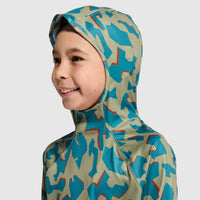 Child wearing camouflage hooded top with sage green and teal pattern, side profile view