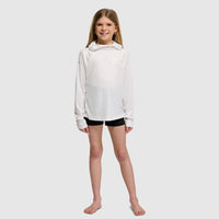 Young girl wearing white hooded sweatshirt with black shorts on clean background