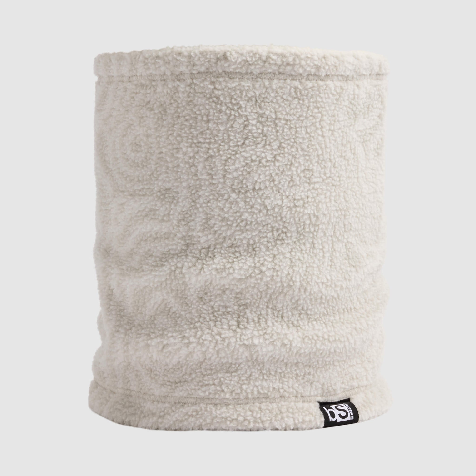 Cylindrical sherpa fleece neck gaiter in light ash gray, front view with small logo tag