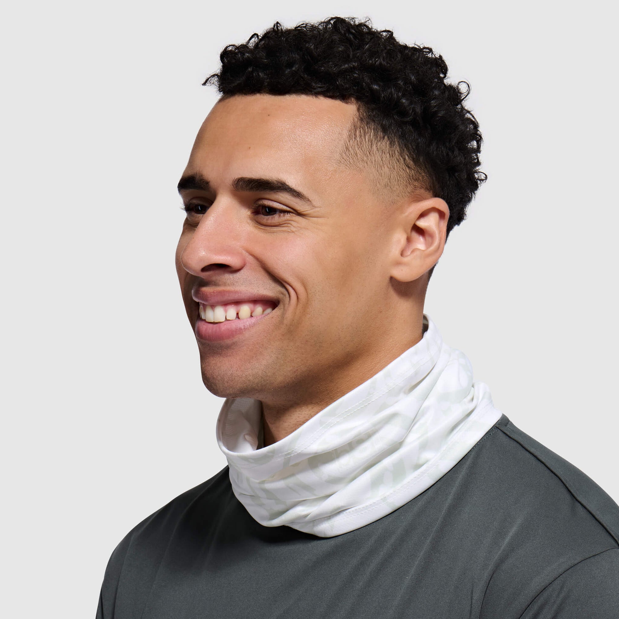 Light gray textured fabric tube neck gaiter worn around neck, lifestyle view