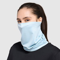 Light blue fabric face covering worn as neck gaiter covering nose and mouth