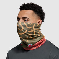 Olive green tube mask with trout pattern and colorful trim worn around neck and face