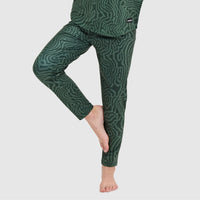 Green patterned base layer pants with topographic design, shown on model from side angle