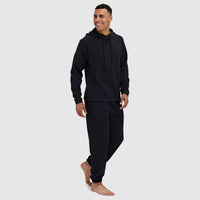 Black pullover hoodie with drawstrings and matching sweatpants on male model