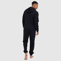 Man wearing black hoodie and matching sweatpants, back view showing hood detail