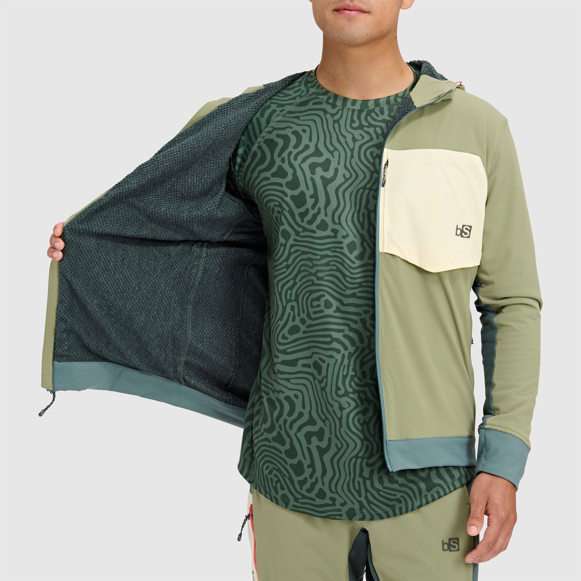 Men's color-blocked fleece jacket with hood, chest pocket, shown unzipped revealing interior mesh lining