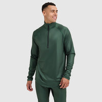 Man wearing dark green quarter-zip athletic pullover with long sleeves, three-quarter front view