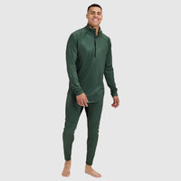 Man wearing forest green quarter-zip base layer top with matching leggings, standing pose