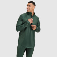 Man wearing dark green quarter-zip athletic pullover with long sleeves against white background