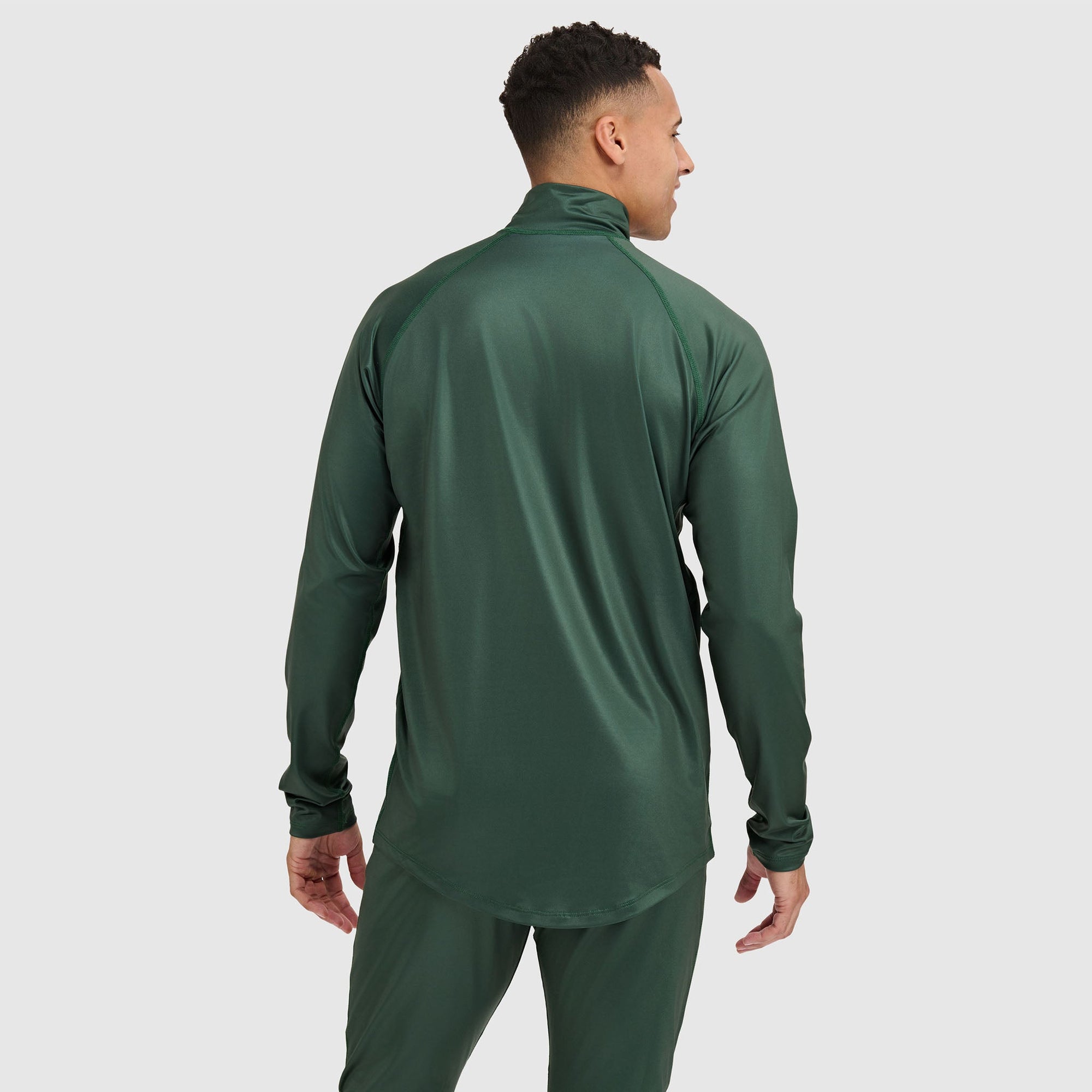 Forest green quarter-zip athletic pullover with long sleeves, rear view on model