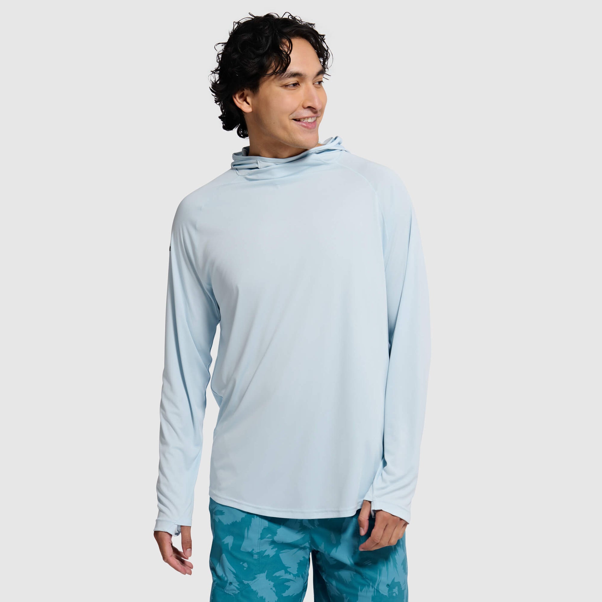 Light blue long-sleeve hoodie with hood up, worn by male model on white background