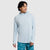 Light blue long-sleeve hoodie with hood up, worn by male model on white background