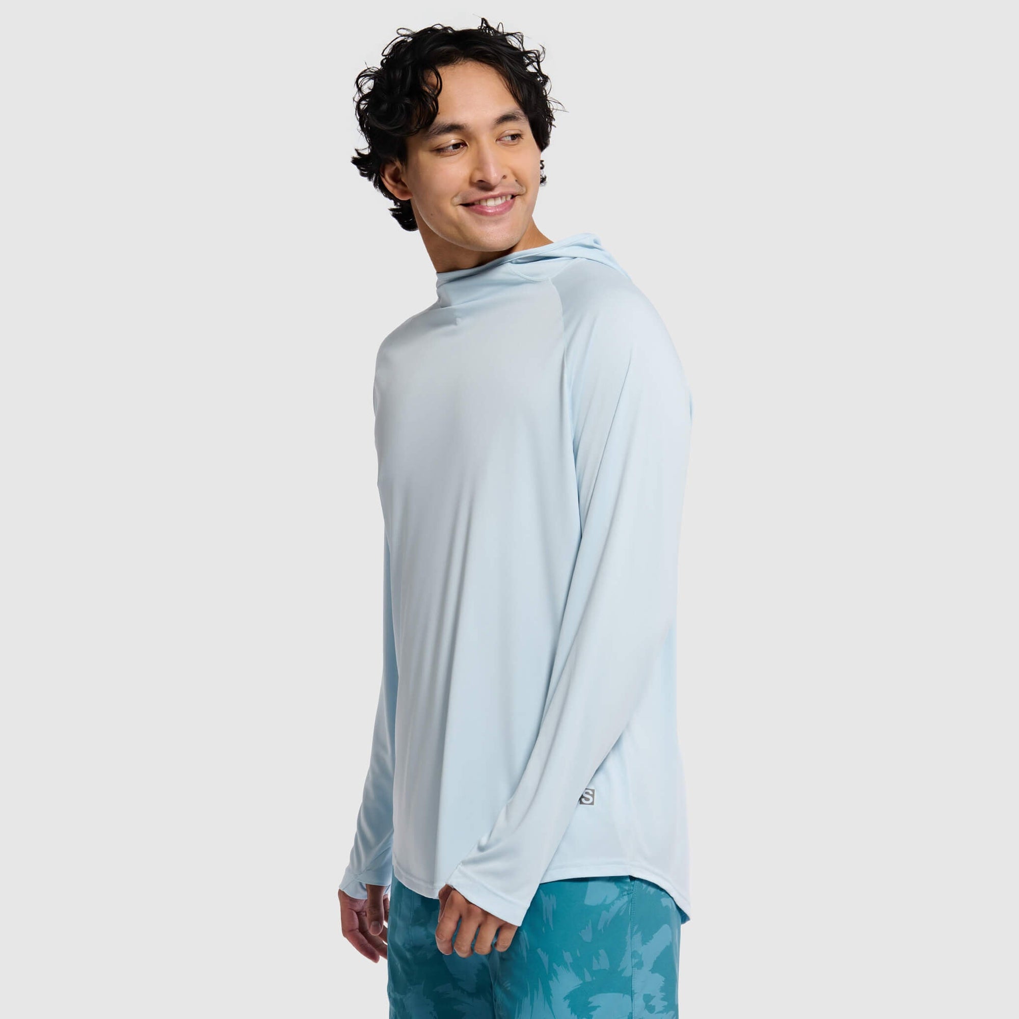 Light blue hooded pullover sweatshirt worn by man against white background