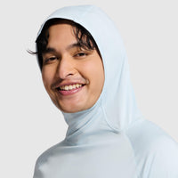 Light blue hooded sweatshirt worn by smiling man, three-quarter view showing hood up