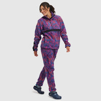 Purple and blue patterned fleece pullover with half-snap closure, worn by woman walking