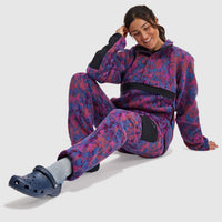 Woman wearing purple and blue patterned fleece pullover with half snap closure and hood