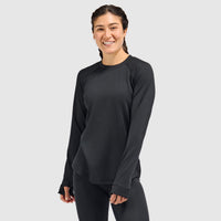 Women's long-sleeve crewneck base layer top in black, front view on model