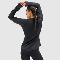 Women's long-sleeve crewneck base layer top, back view, model stretching arms overhead