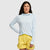 Light blue pullover hoodie with drawstring hood worn by woman against white background