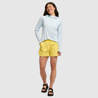 Light blue hooded long-sleeve top worn by woman in casual outfit