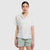 Light blue short-sleeve camp shirt with yellow polka dot pattern, worn by woman